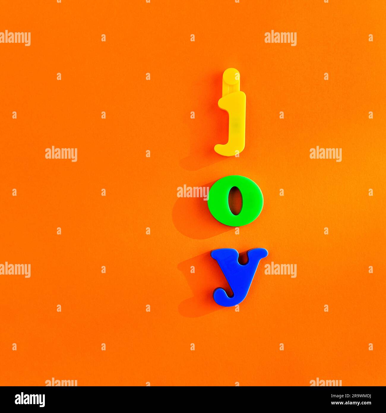 Colourful letters form the word joy, tabletop, vertical arrangement, minimalist, symbol image joy Stock Photo