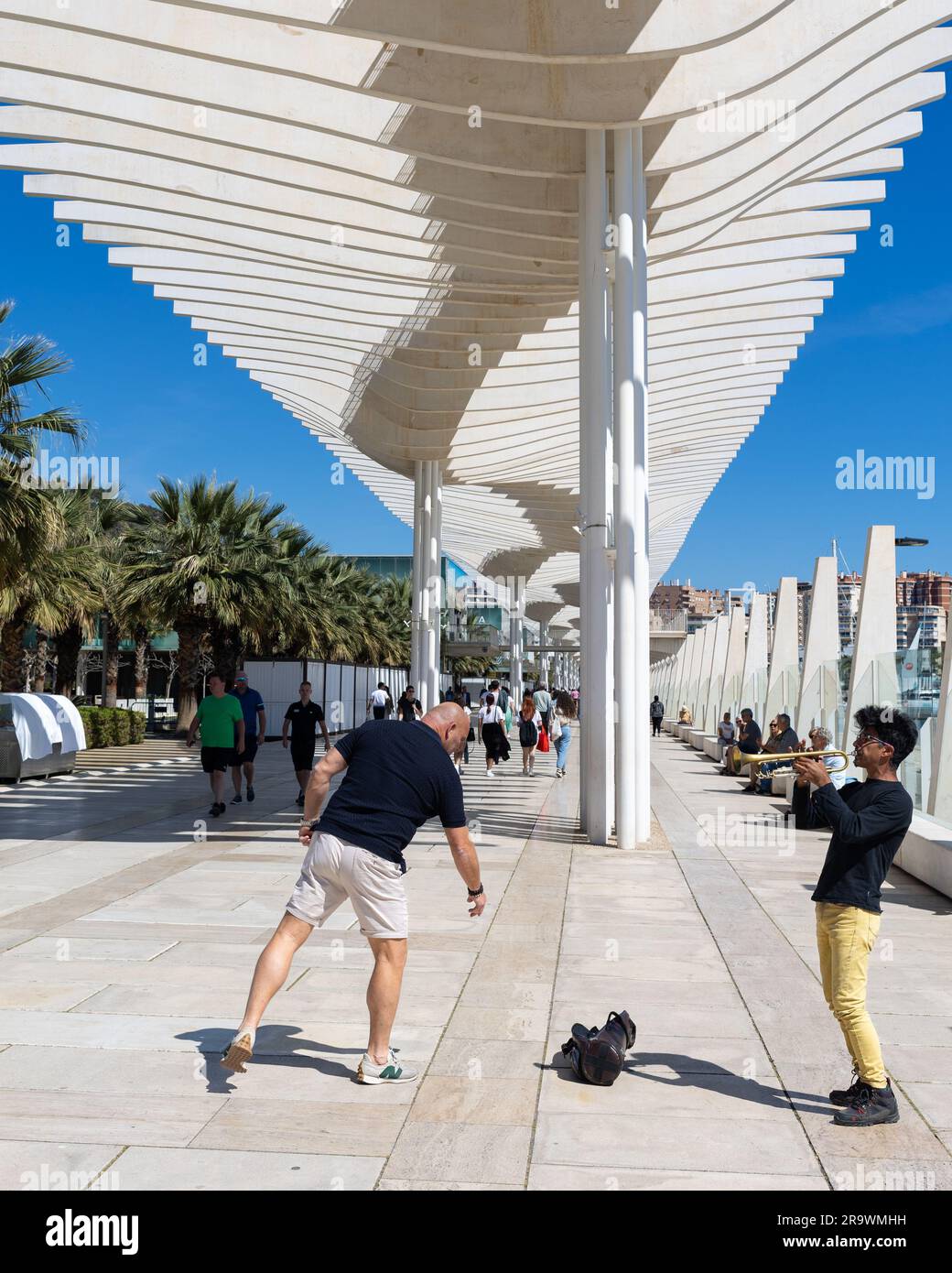 A street artist playing at the Promenade ( Paseo) Muelle Uno, Malaga, Spain Stock Photo