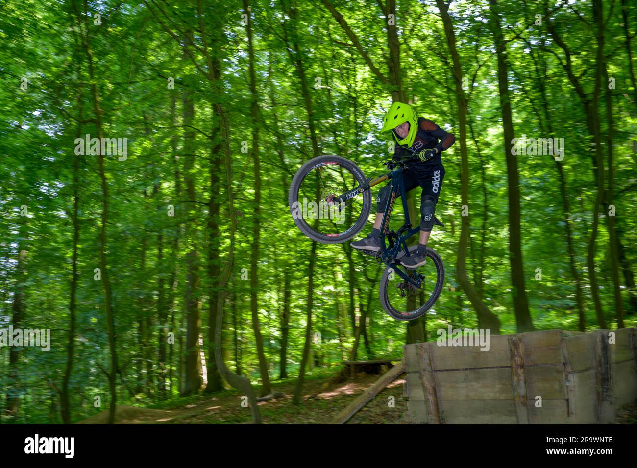 Mountain biker, downhill biker jumps over a ramp on a downhill trail, Gudensberg, Hesse, Germany Stock Photo