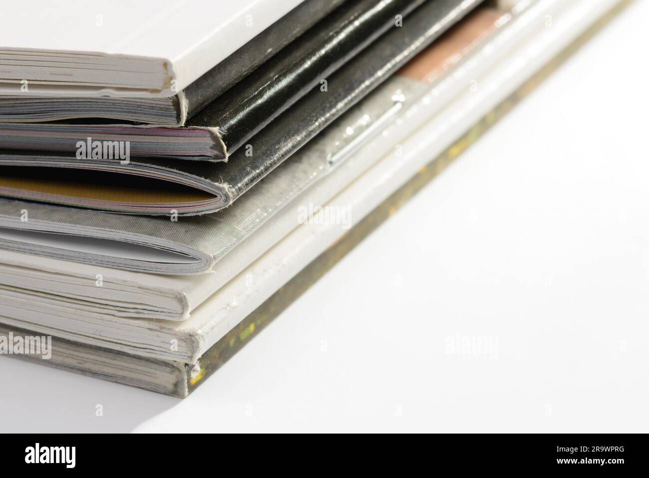 A pile of different catalogs on white background Stock Photo Alamy