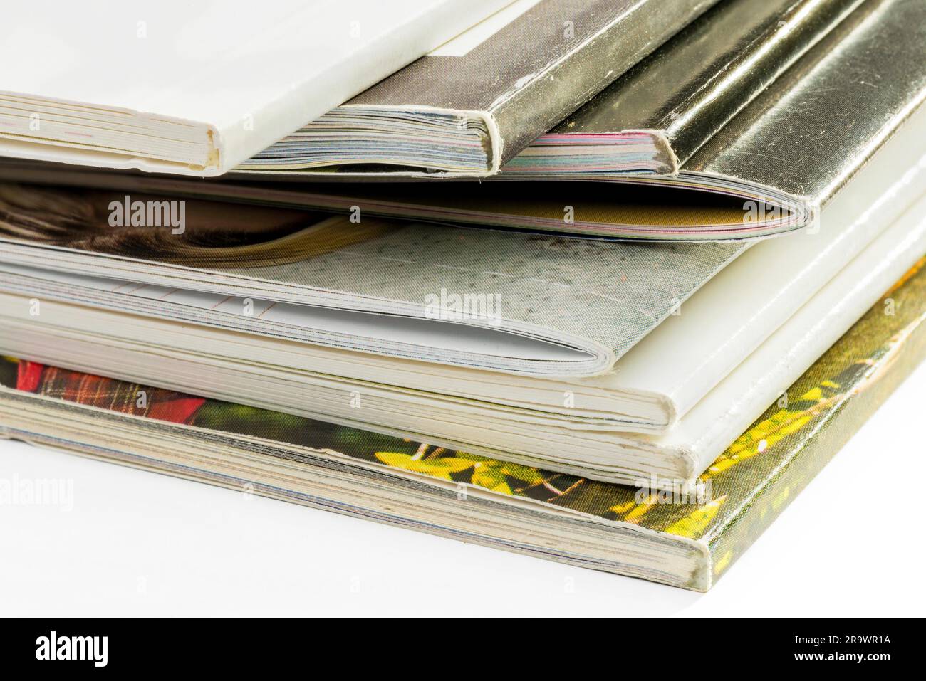 A pile of different catalogs on white background Stock Photo Alamy