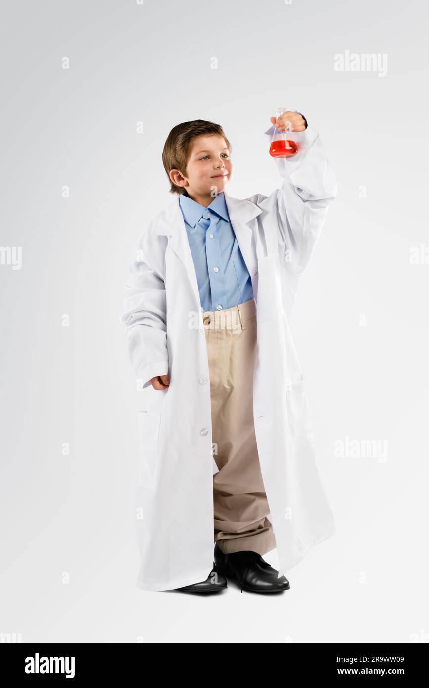 Science, chemicals and boy child in studio doing a chemistry experiment