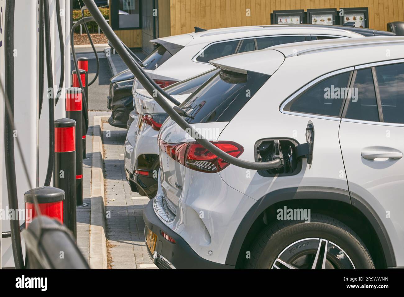 The future is here: electric vehicles charging at an electric vehicle (EV) charging station; near Stafford, England, Great Britain. Stock Photo