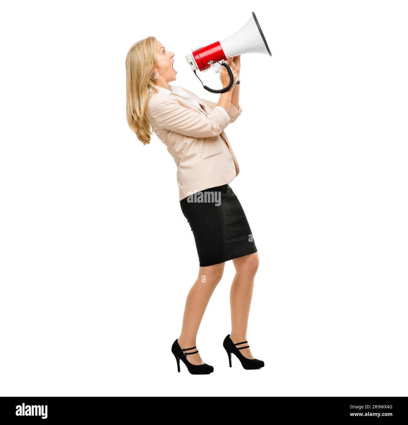 Megaphone, noise and screaming mature woman in studio with message, broadcast or announcement on white background. Speaker, speech and angry lady with Stock Photo