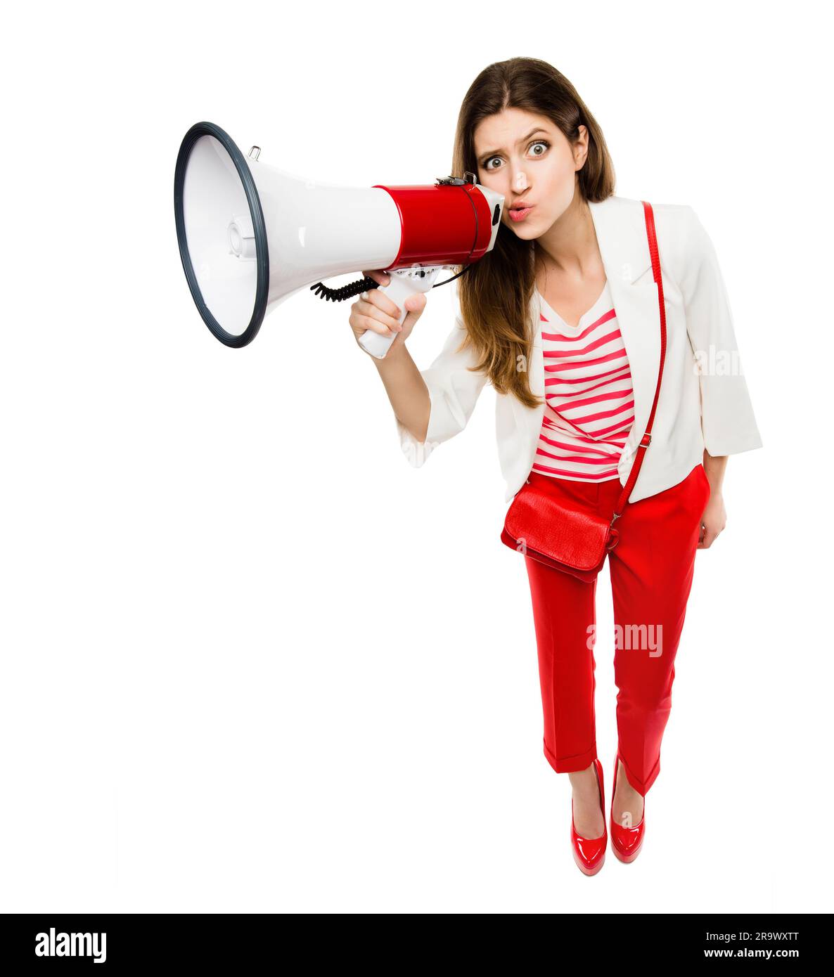 Megaphone, fashion and portrait of a woman in studio for serious announcement, voice or speech. Weird and comic female model in trendy red clothes Stock Photo