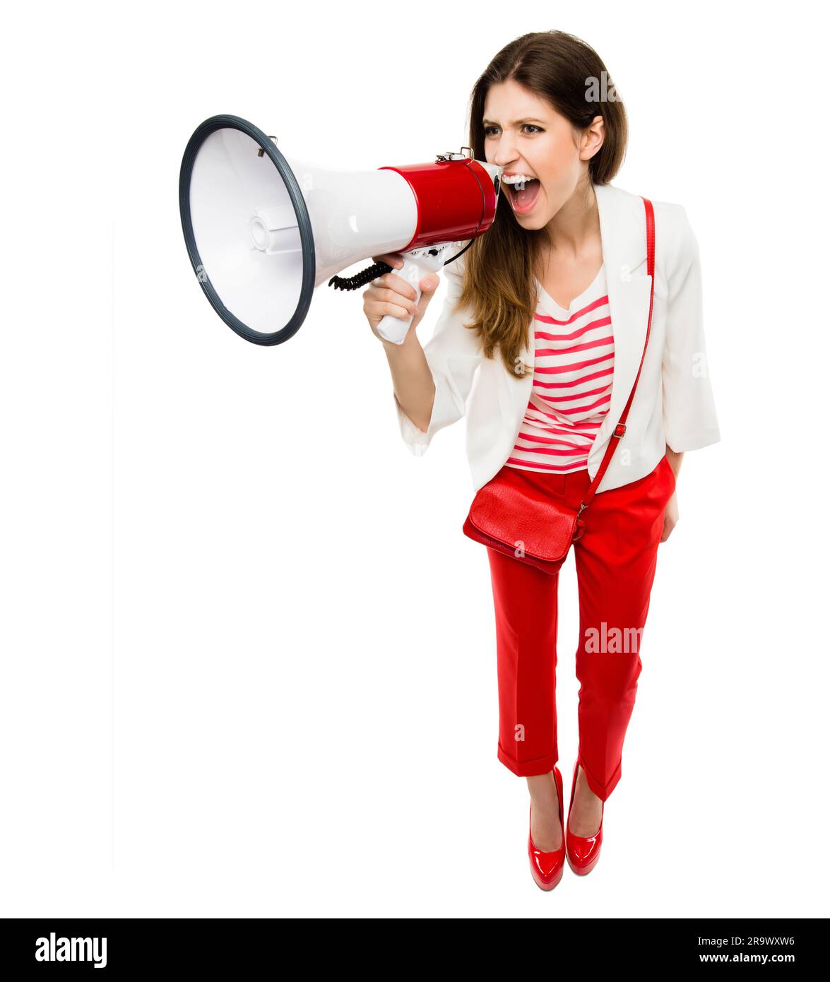 Fashion, megaphone and a woman shouting in studio for serious announcement, voice or speech. Frustrated female model in stylish red clothes with a Stock Photo