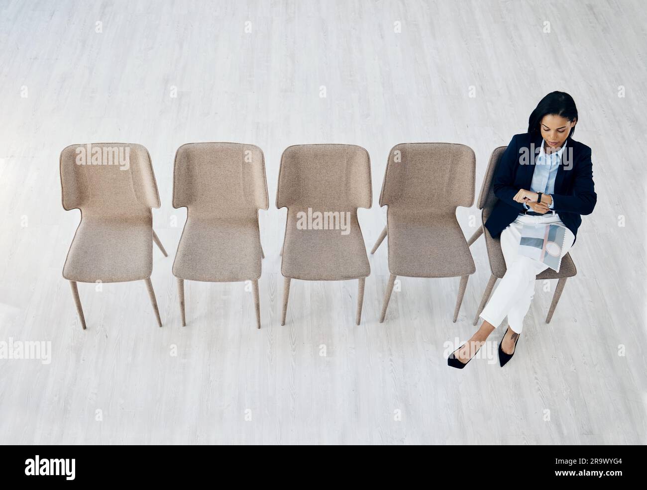Business woman, checking watch and waiting room sitting on chairs above ...