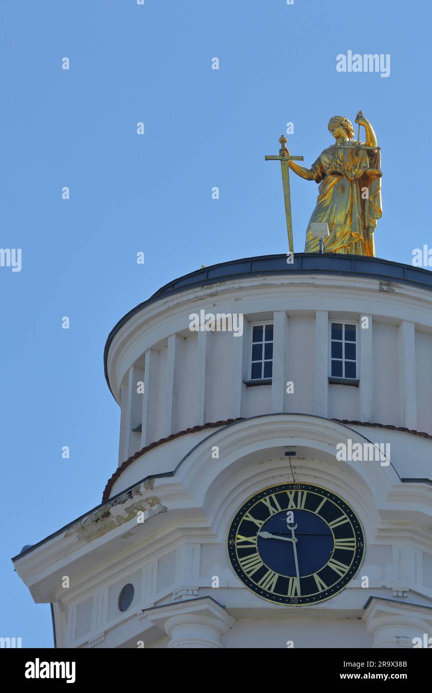 Golden sculpture Themis with sword and beam scales, Greek goddess for justice, custom and order, on the roof of the town hall, clock, scales, law Stock Photo