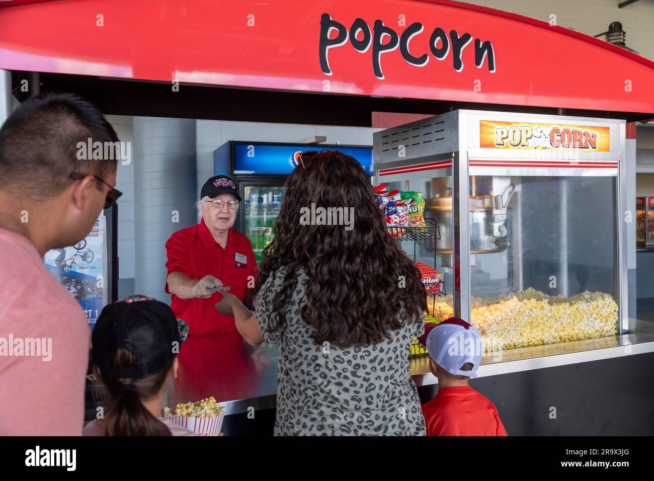 Lansing, Michigan, A vendor takes a credit card for popcorn payment at Jackson Field during a Lansing Lugnuts baseball game. Stock Photo