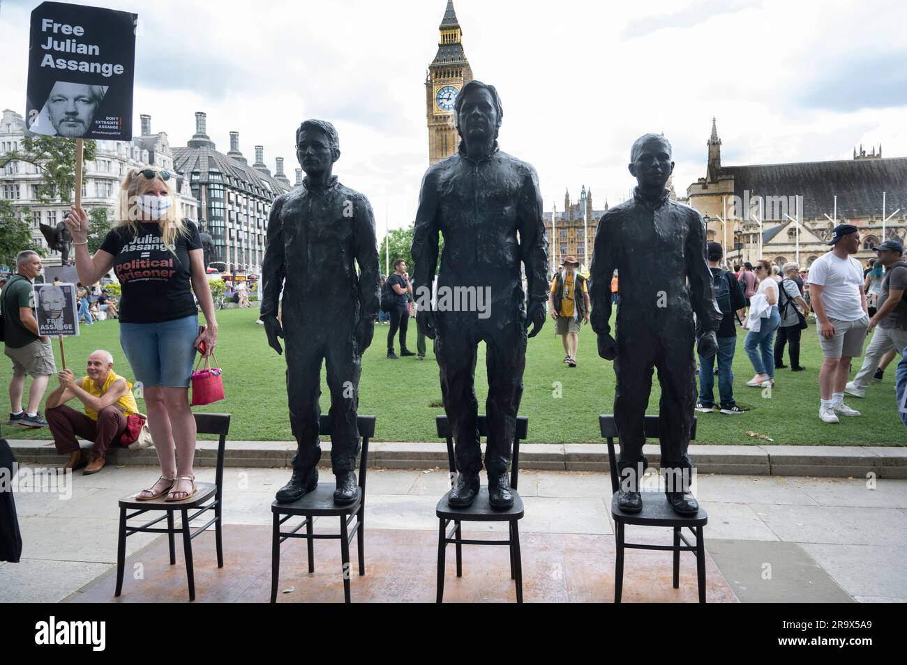 Parliament Square, London. Sculptures of Edward Snowden, Julian Assange and Chelsea Manning by Italian sculptor Davide Domino during a demonstration t Stock Photo