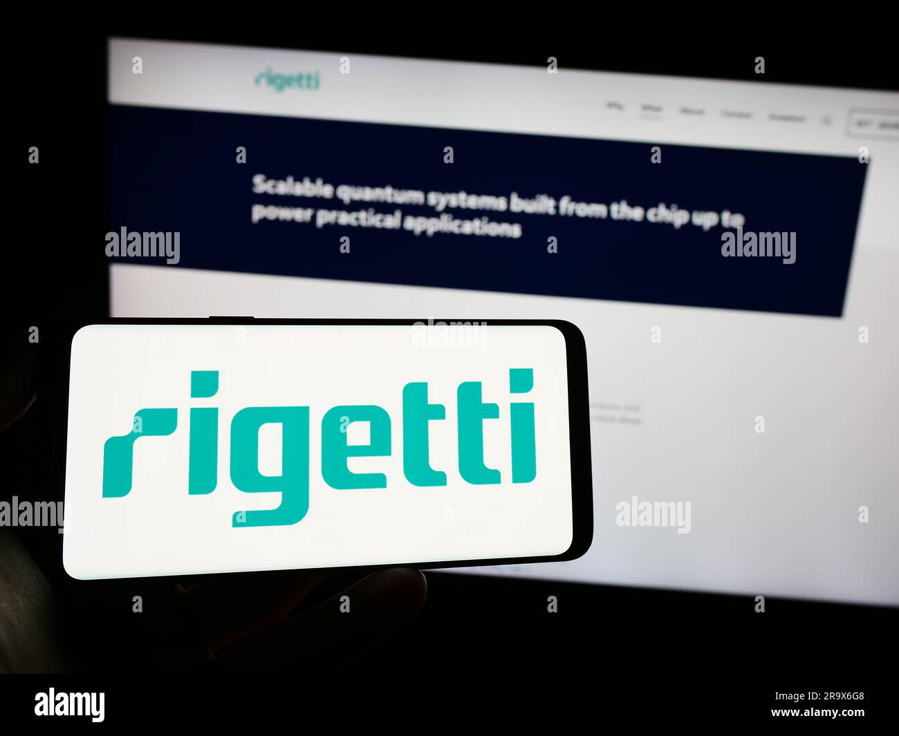 Person holding cellphone with logo of us company rigetti computing inc