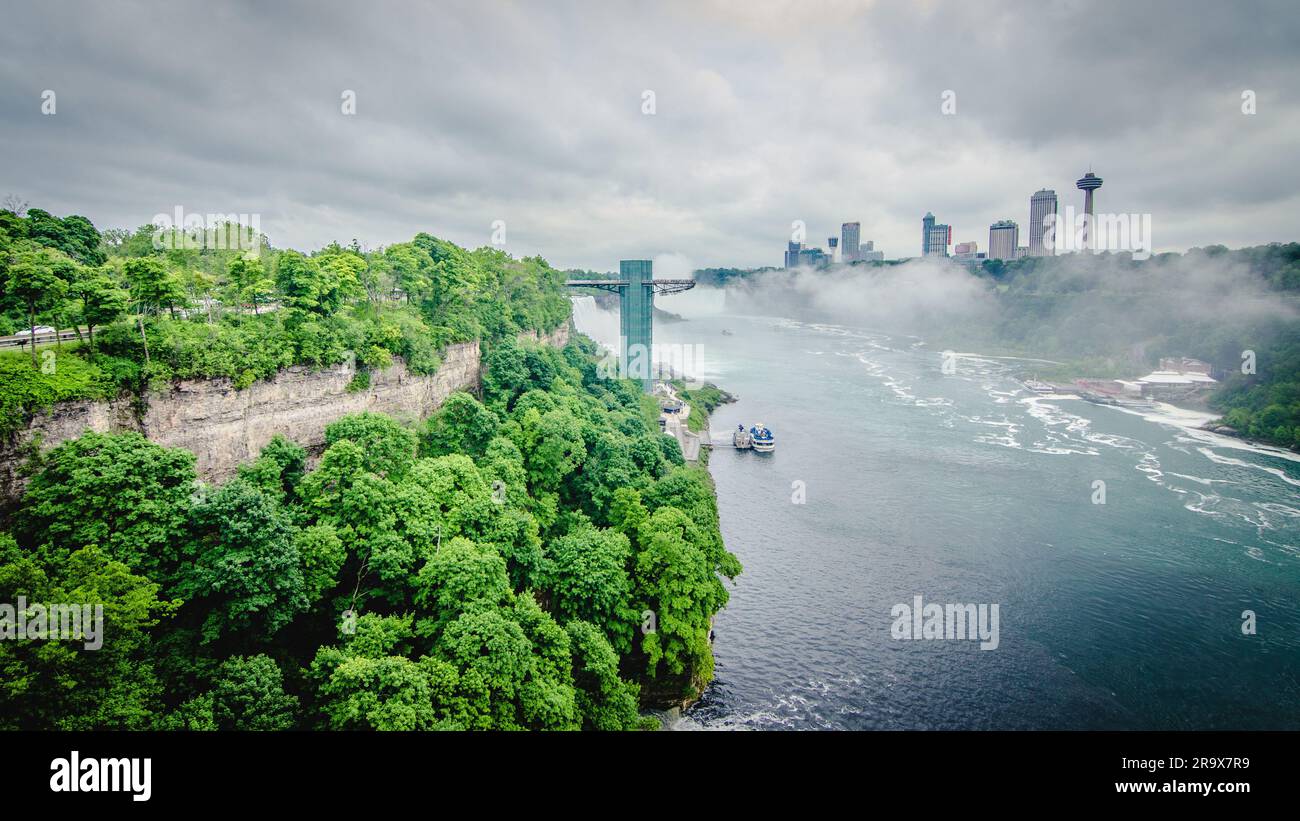 Aerial view of a magnificent waterfall cascading down into a lush green ...
