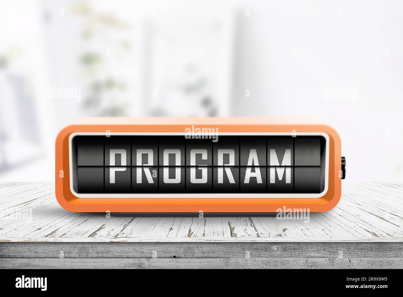 Program message on a retro clock in orange on a wooden table in bright light Stock Photo