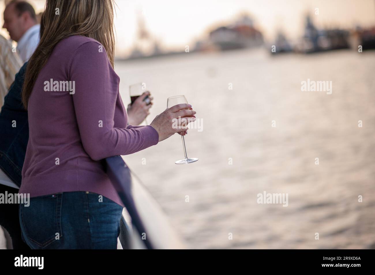 Women drinking wine on a boat at sunset Stock Photo - Alamy