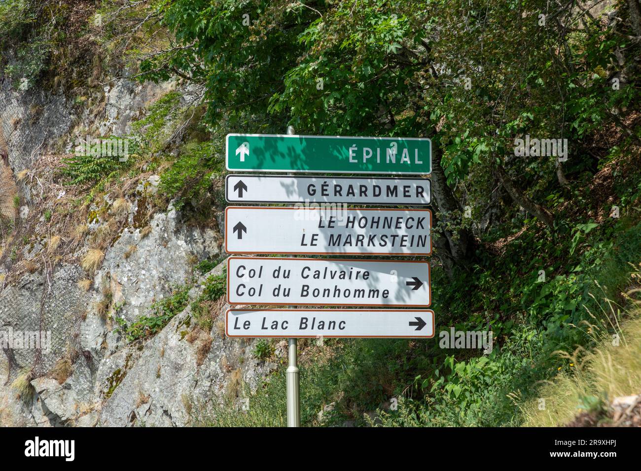 street sign with arrow in the Vosges to EPINAL, GERARDMER, LE HOHNECK, LE LAC BLANC AND COL DU Bonhomme in France Stock Photo