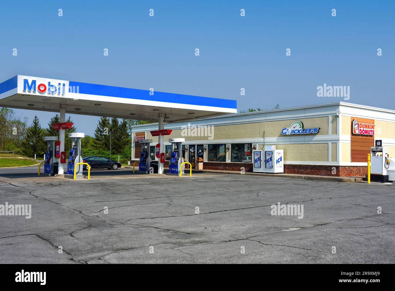Watertown, NY, USA - May 22, 2023: Mobil Oil gas station with Quicklee's and Dunkin' Donuts. Quicklee’s is a convenience store chain in Upstate New Yo Stock Photo