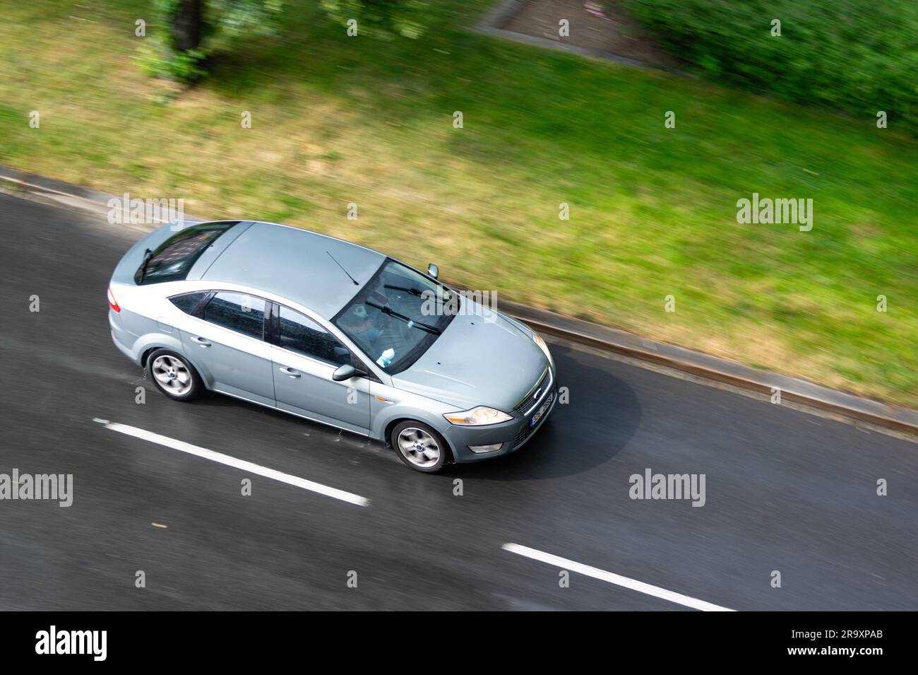 OSTRAVA, CZECH REPUBLIC - JUNE 21, 2023: Ford Mondeo Mk4 liftback driving on a wet road after rain with motion blur effect Stock Photo