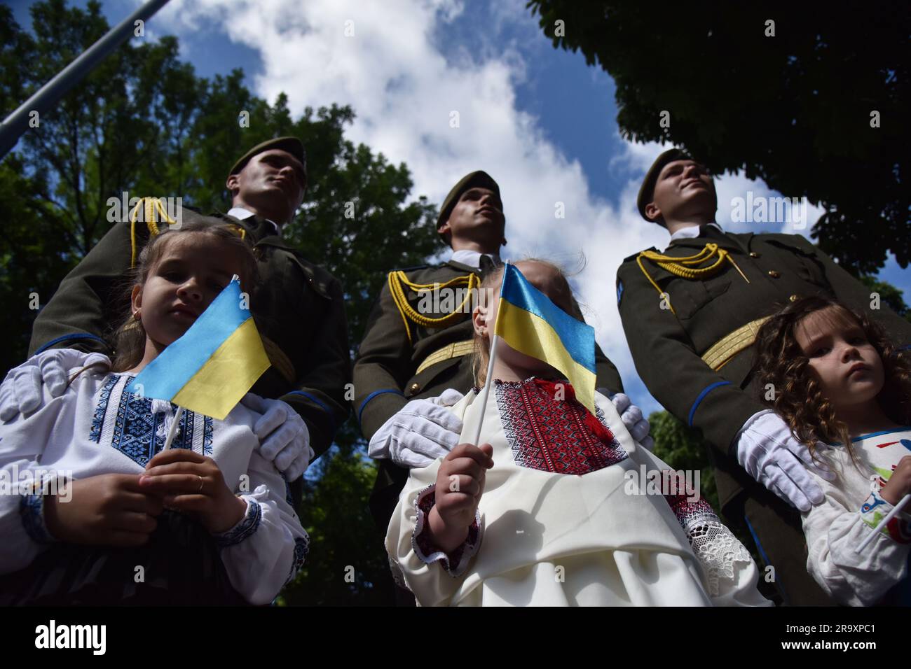 Children with Ukrainian flags during the celebration of the Constitution Day of Ukraine. Ukraine celebrated the 27th anniversary of the adoption of the country's basic law - the constitution. In the conditions of the Russian-Ukrainian war, official events were very short. In Lviv, the Ukrainian flag was raised, honor guard marched, and a military band performed. (Photo by Pavlo Palamarchuk / SOPA mages/Sipa USA) Stock Photo