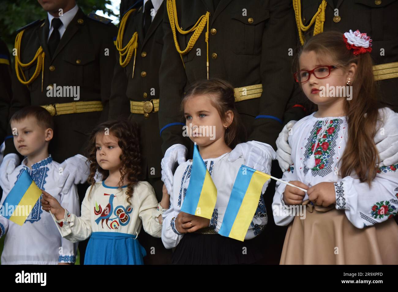 Children with Ukrainian flags during the celebration of the Constitution Day of Ukraine. Ukraine celebrated the 27th anniversary of the adoption of the country's basic law - the constitution. In the conditions of the Russian-Ukrainian war, official events were very short. In Lviv, the Ukrainian flag was raised, honor guard marched, and a military band performed. (Photo by Pavlo Palamarchuk / SOPA mages/Sipa USA) Stock Photo