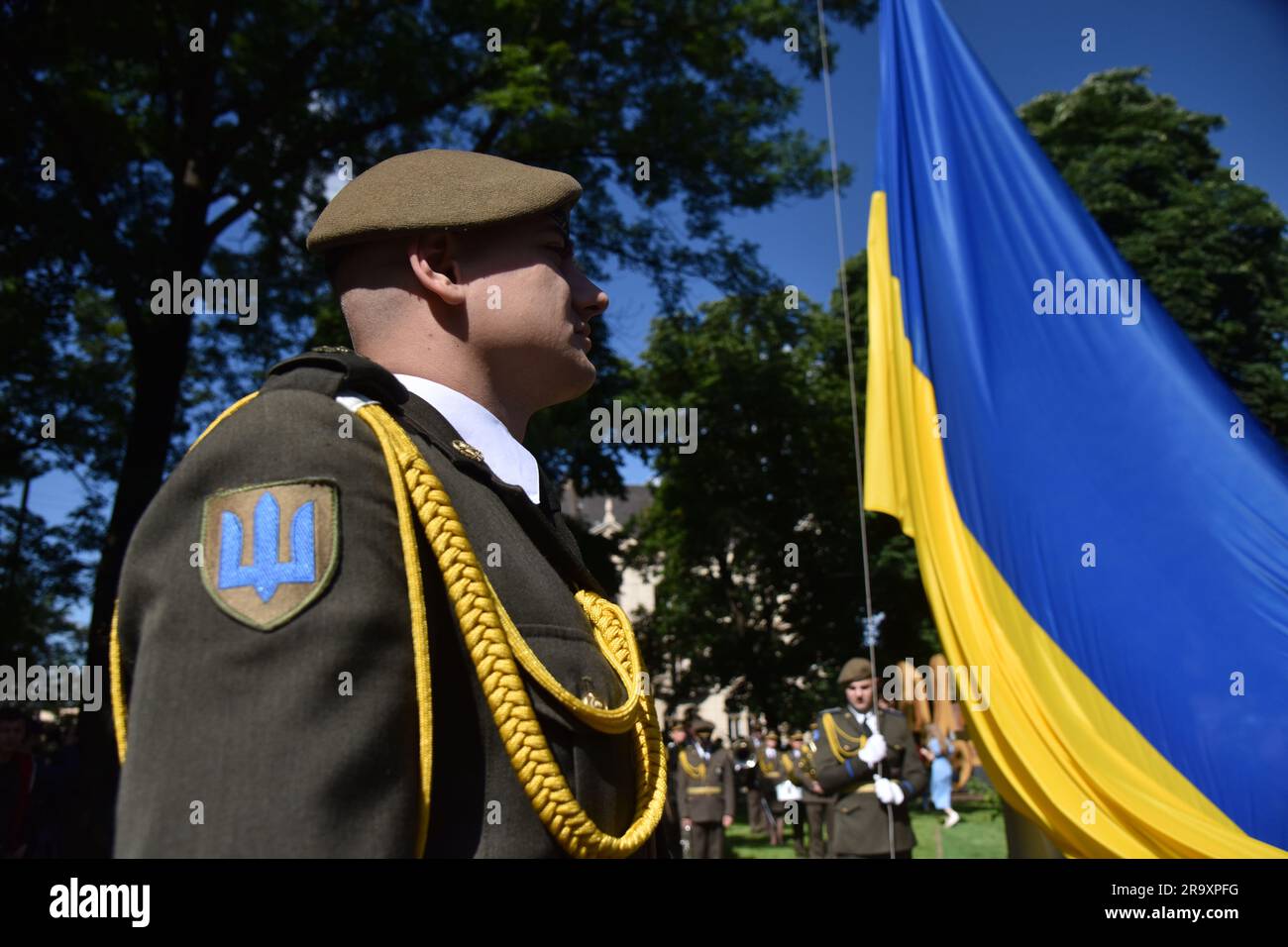 The ceremony of raising the national flag during the celebration of the Constitution Day of Ukraine. Ukraine celebrated the 27th anniversary of the adoption of the country's basic law - the constitution. In the conditions of the Russian-Ukrainian war, official events were very short. In Lviv, the Ukrainian flag was raised, honor guard marched, and a military band performed. (Photo by Pavlo Palamarchuk / SOPA mages/Sipa USA) Stock Photo