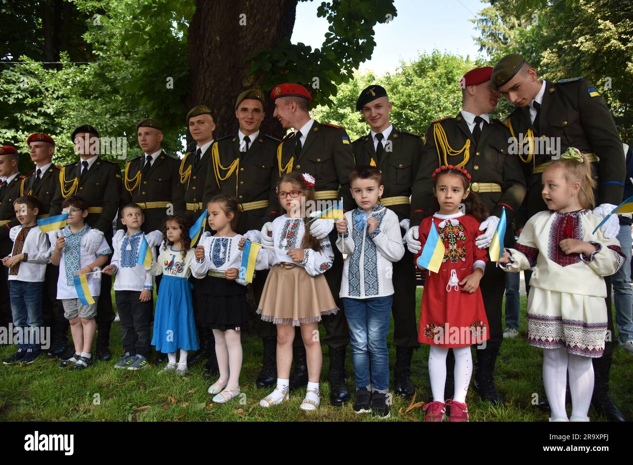 Cadets stand with children during the celebration of the Constitution Day of Ukraine. Ukraine celebrated the 27th anniversary of the adoption of the country's basic law - the constitution. In the conditions of the Russian-Ukrainian war, official events were very short. In Lviv, the Ukrainian flag was raised, honor guard marched, and a military band performed. (Photo by Pavlo Palamarchuk / SOPA mages/Sipa USA) Stock Photo