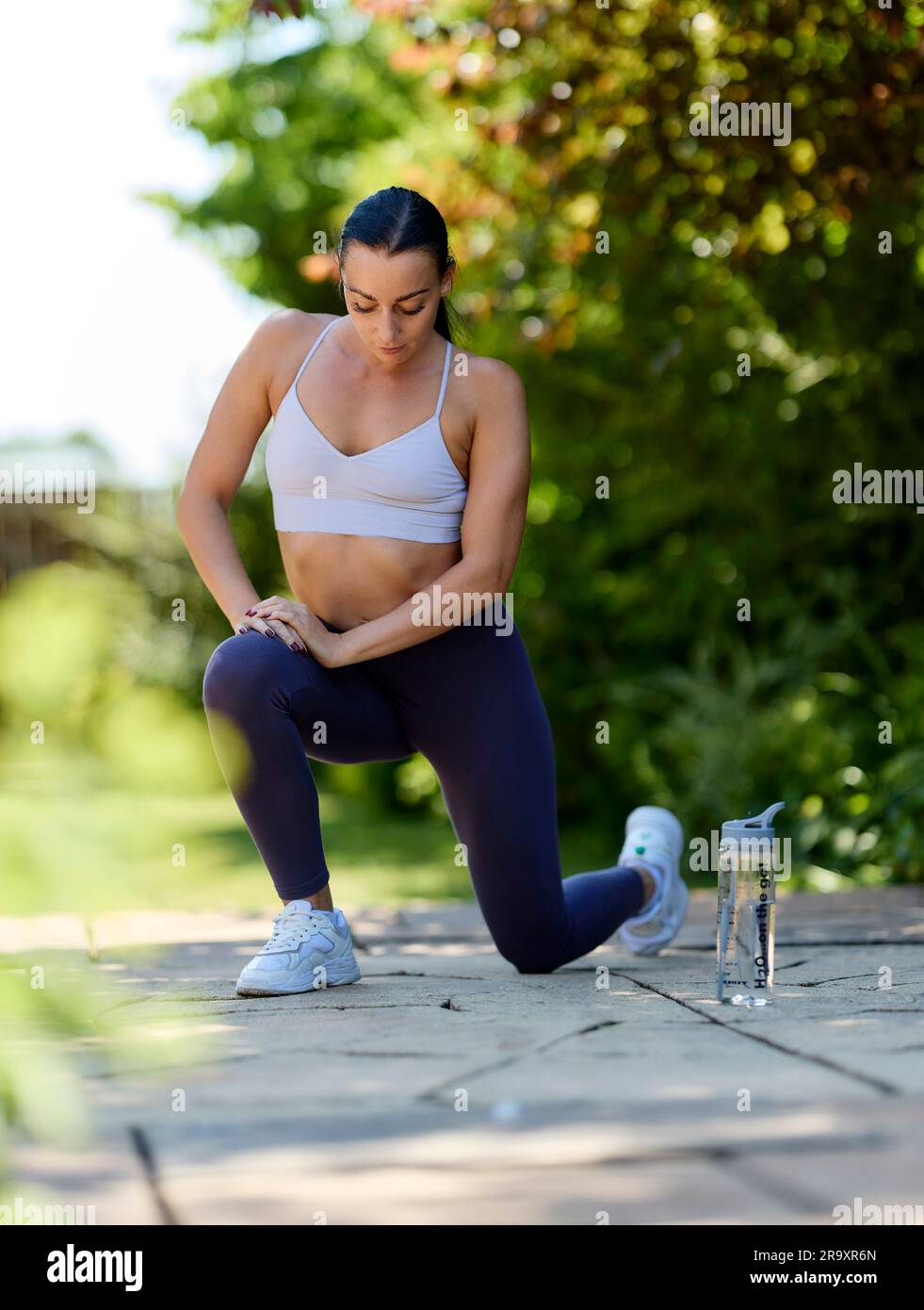 Woman exercising outdoors Stock Photo