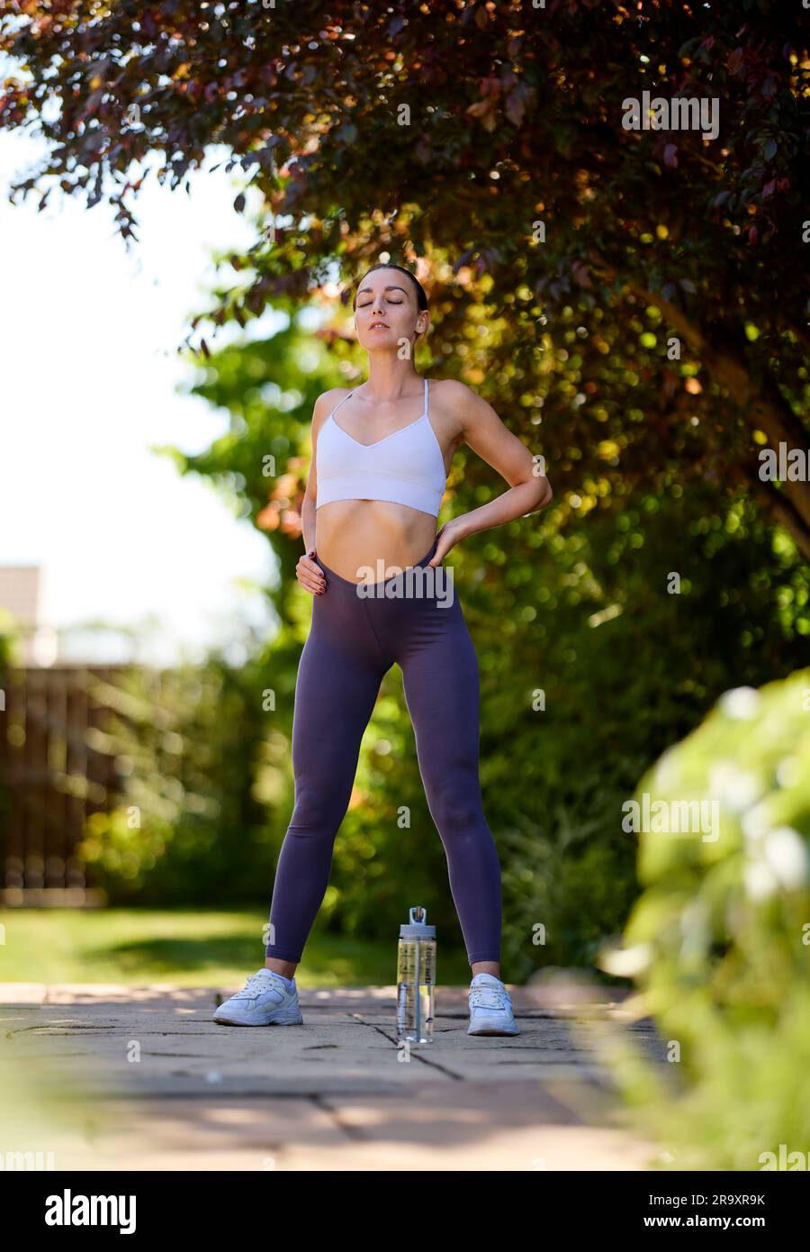 Woman exercising outdoors Stock Photo