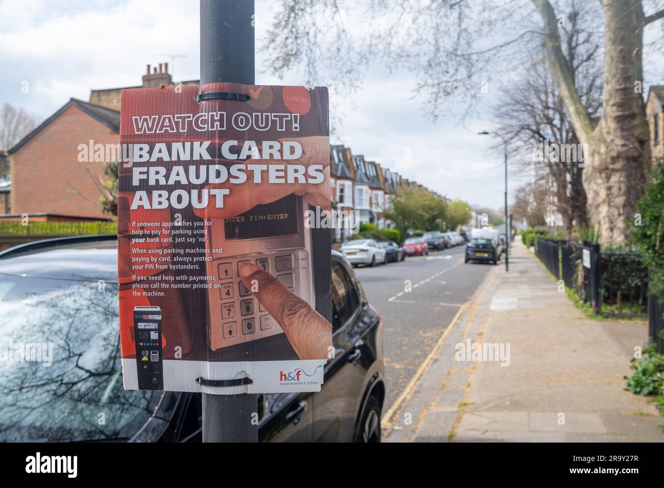 LONDON- April, 2023: Bank Card Fraud warning poster on residential street in Fulham- warning about parking scam Stock Photo