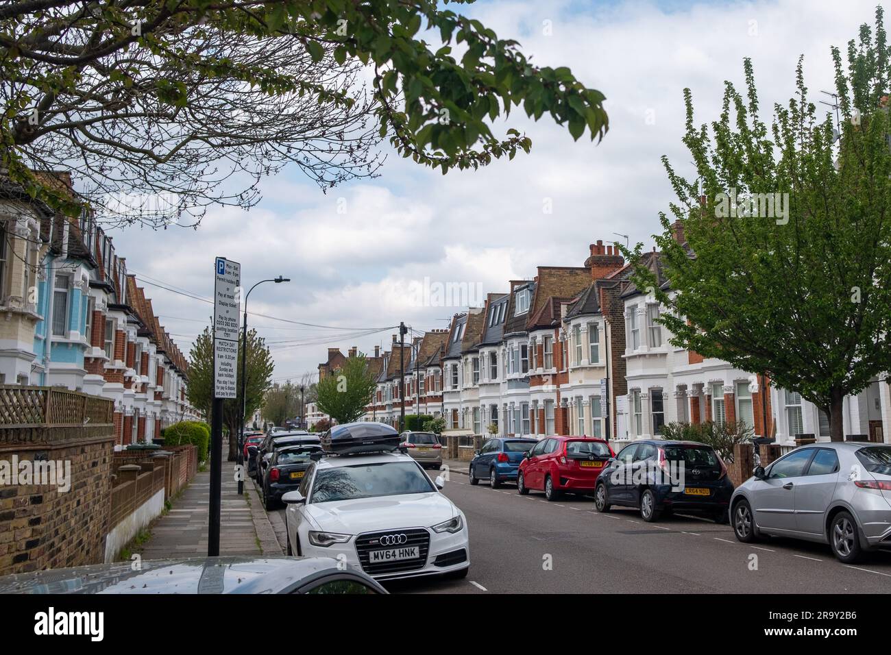 LONDON- APRIL, 2023: Street of typical terraced houses in Fulham, off Fulham Palace Road in SW6 Stock Photo