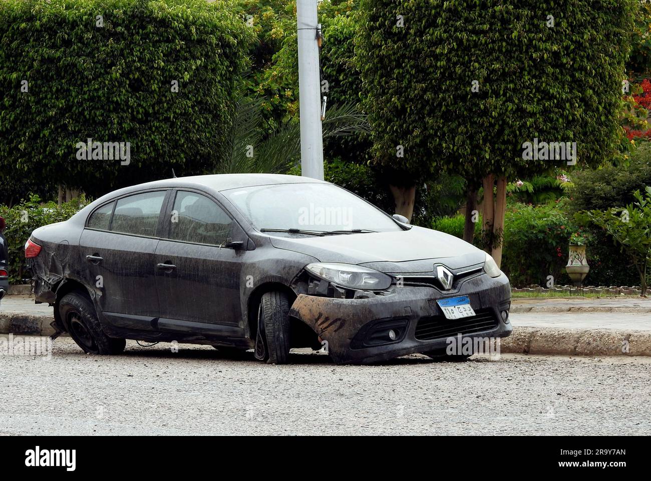 Cairo, Egypt, June 6 2023 Black wrecked car damaged by accident on the