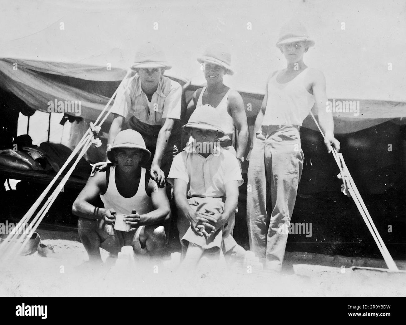 A military group beside a tent, Palestine, c1930. This is a photograph from an album of mainly snapshots, c1929, during the occupation of Palestine by the British Army, with photos from Palestine and UK including Devil's Jump near Churt in Surrey and Devil’s Punch Bowl. Training seems to be at Hursley Camp, near Winchester. Great Britain administered Palestine on behalf of the League of Nations between 1920 and 1948, a period referred to as the 'British Mandate'. Stock Photo