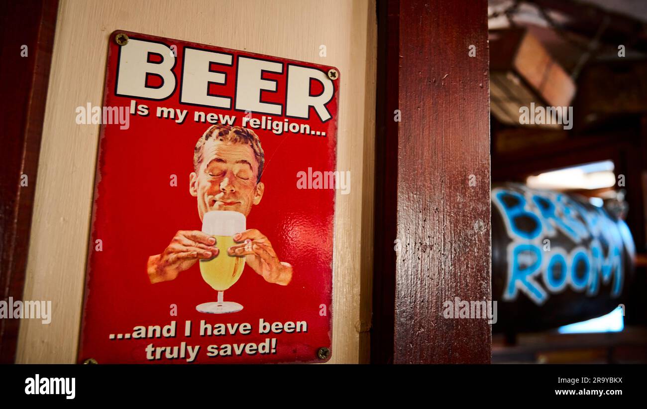 1950's style metal advertising plaque on wall of traditional real ale pub Stock Photo