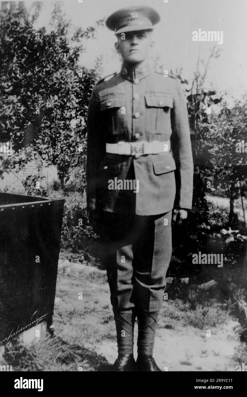 A soldier in uniform standing in a garden. Photo from a family album of images mainly taken in the UK, around 1929. The family lived in Witley, Surrey, and had some links to the military. Stock Photo
