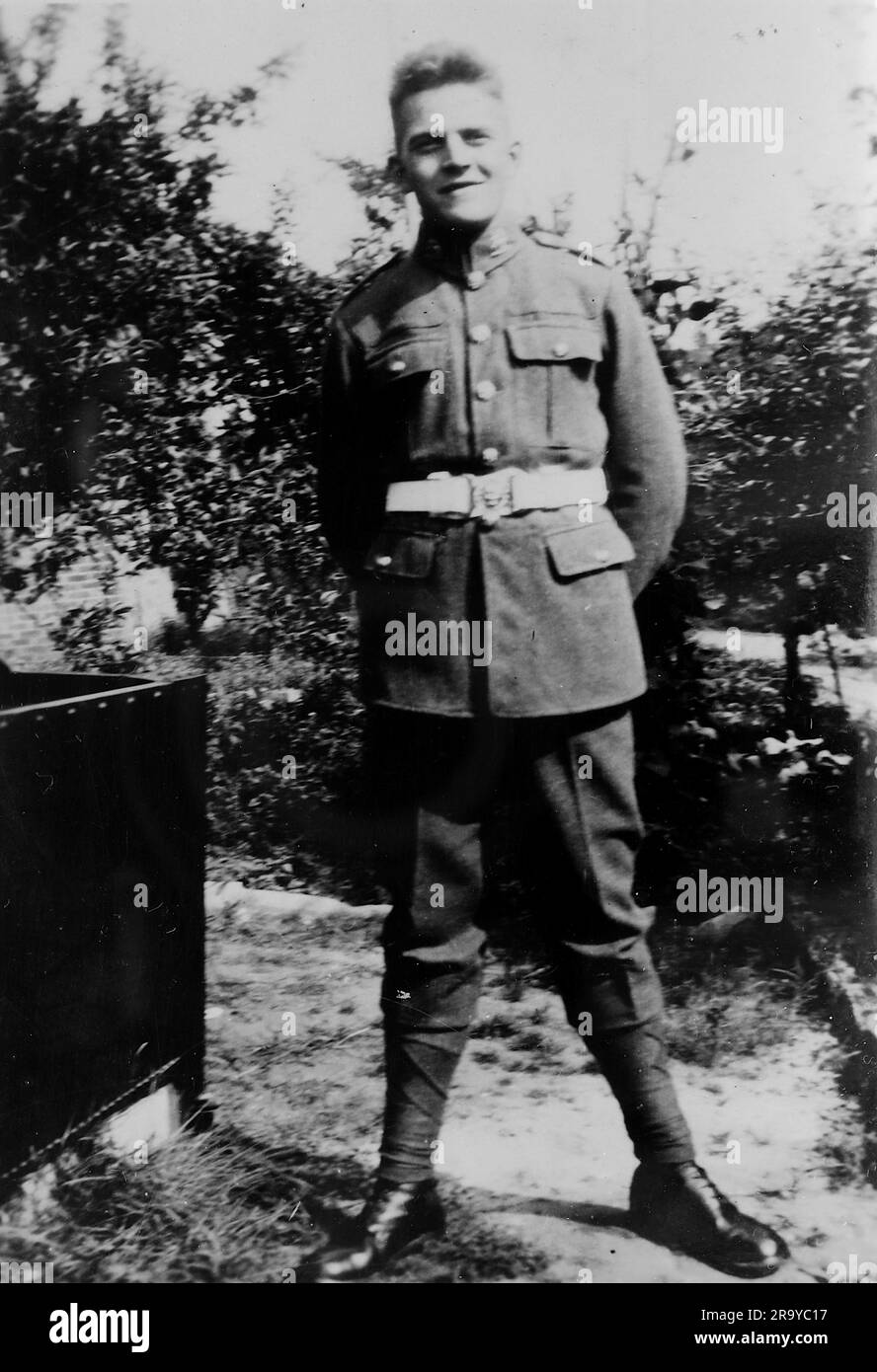 A soldier in uniform in an English garden. Photo from a family album of images mainly taken in the UK, around 1929. The family lived in Witley, Surrey, and had some links to the military. Stock Photo
