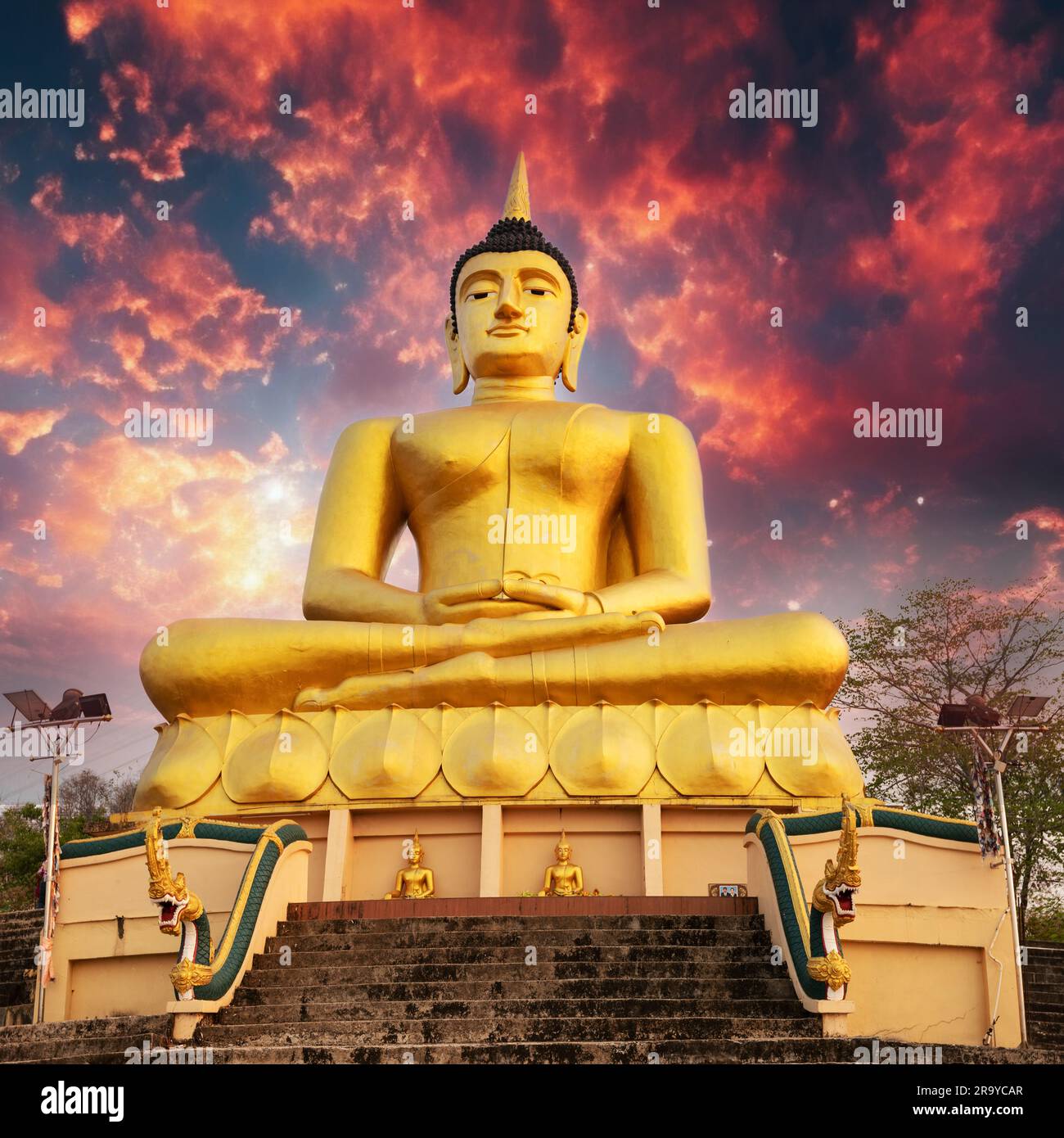 Golden Buddha overlooking Pakse at sunset. Wat Phousalao. Laos Stock Photo