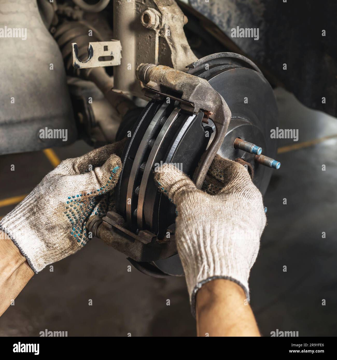 Auto mechanic installed new brake pads and disc for the brake system of