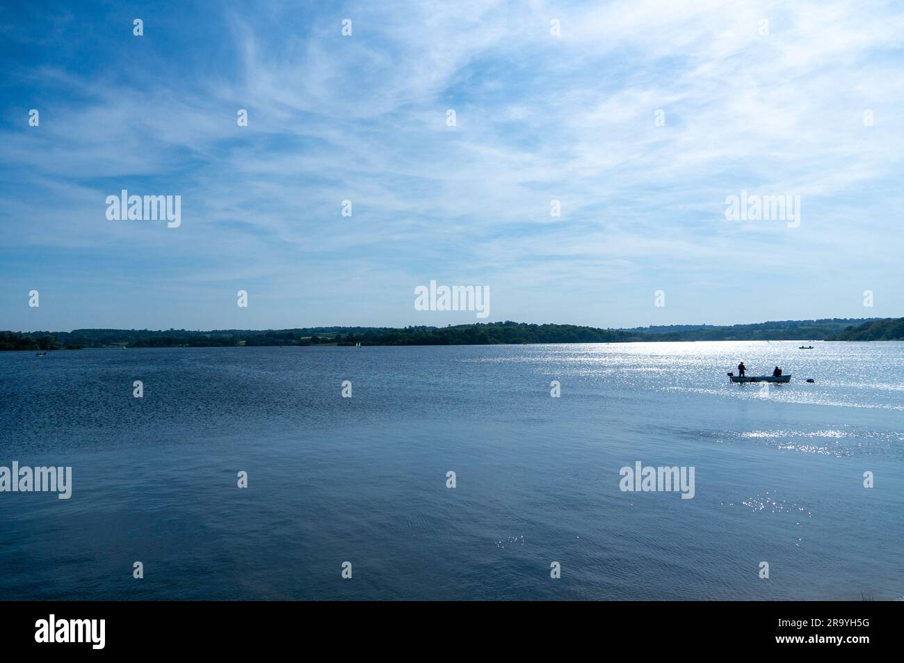 Serene lake view of people fishing Stock Photo