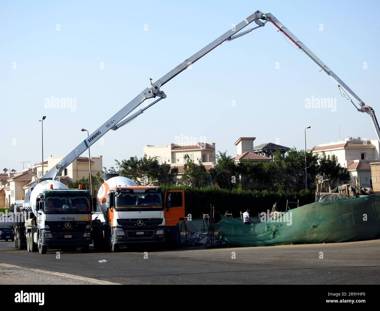 Cairo, Egypt, June 17 2023: A truck-mounted concrete boom pump at the side of the road pouring concrete to a new building, selective focus of concrete Stock Photo