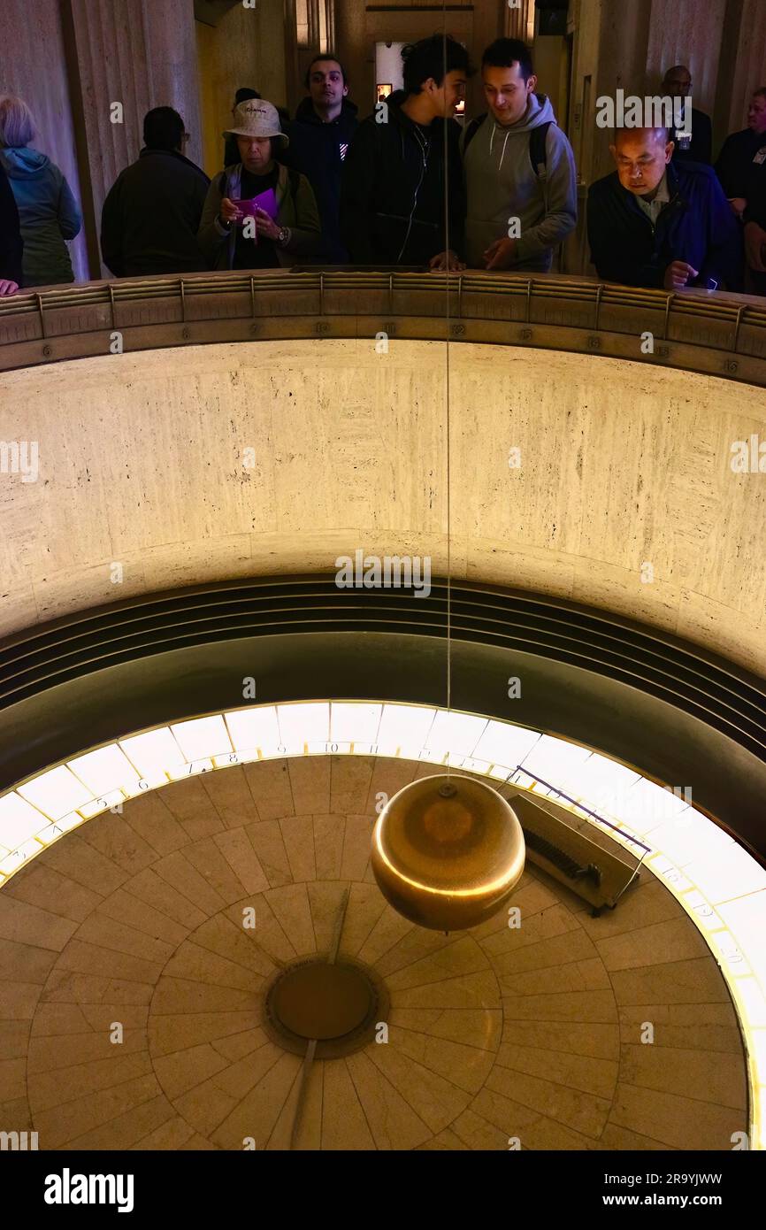 Tourists at The Foucault Pendulum in the Keck Central Rotunda Griffith Observatory Griffith Park Los Angeles California USALos Angeles California USA Stock Photo