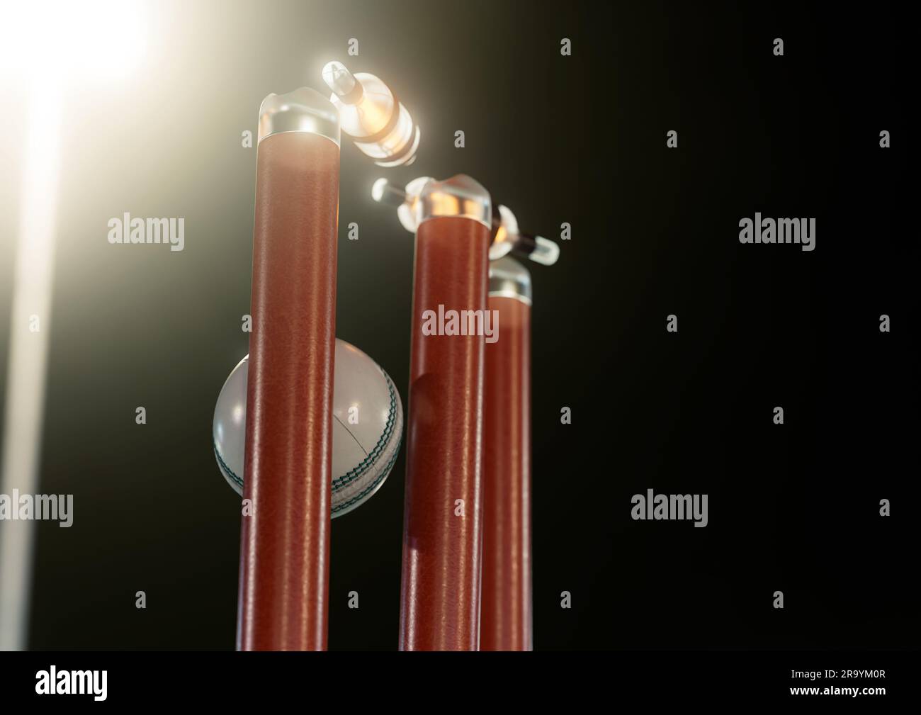 A white cricket ball striking orange electronic cricket wickets with