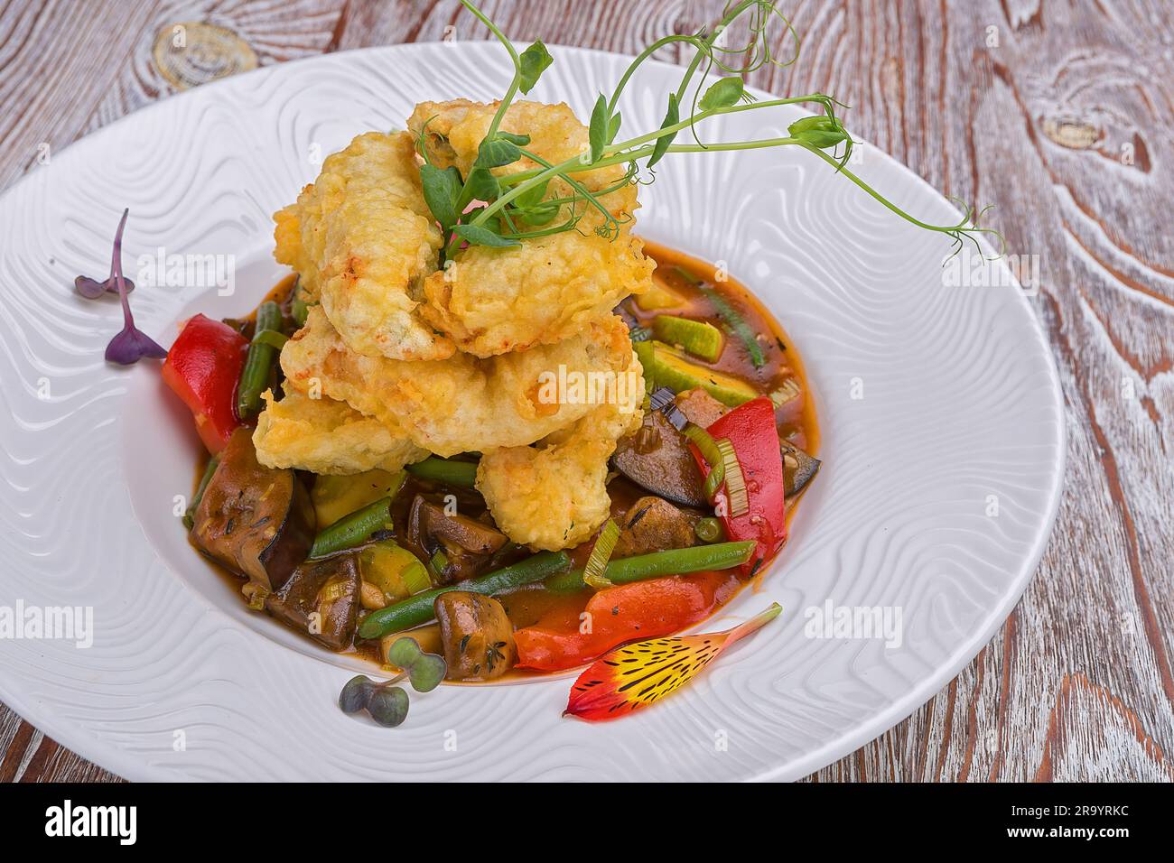 Tempura shrimp with vegetable saute and mushrooms Stock Photo