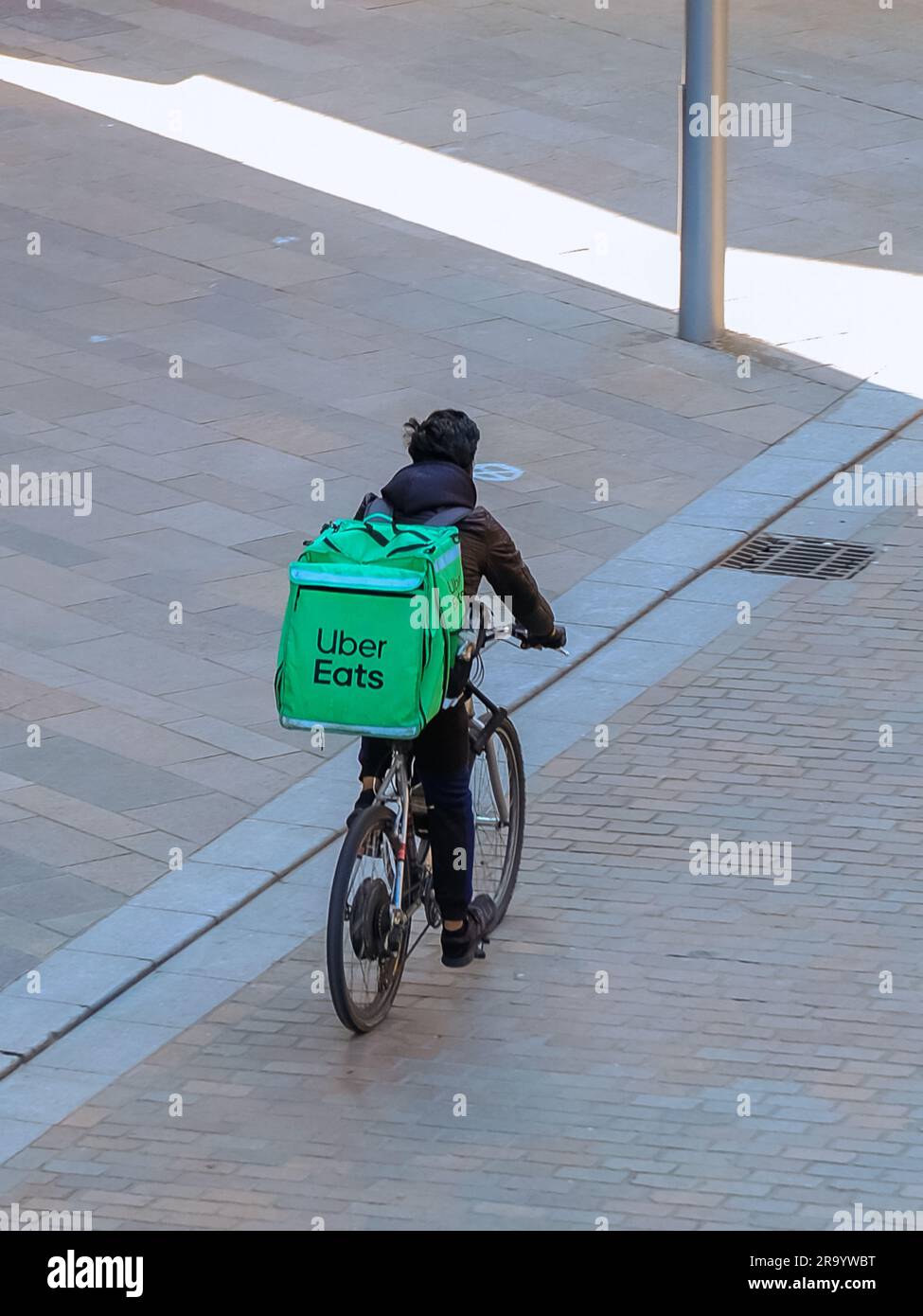 Mobile food delivery by cycle for Uber Eats.  Popular app which allows customers to order take away to their homes. Stock Photo