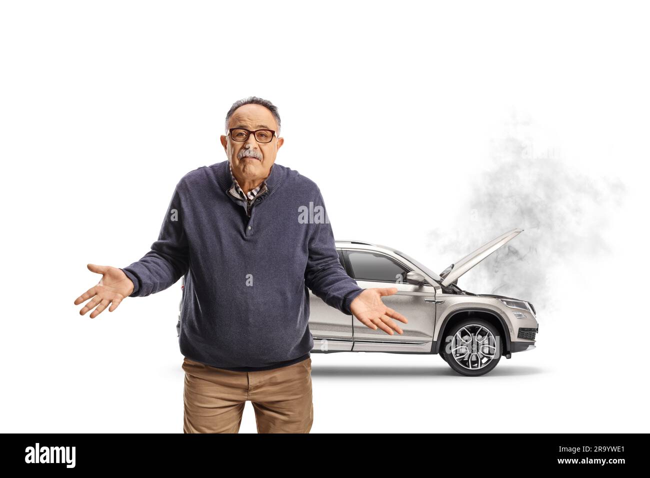 Confused mature man standing in front of a broken car isolated on white background Stock Photo