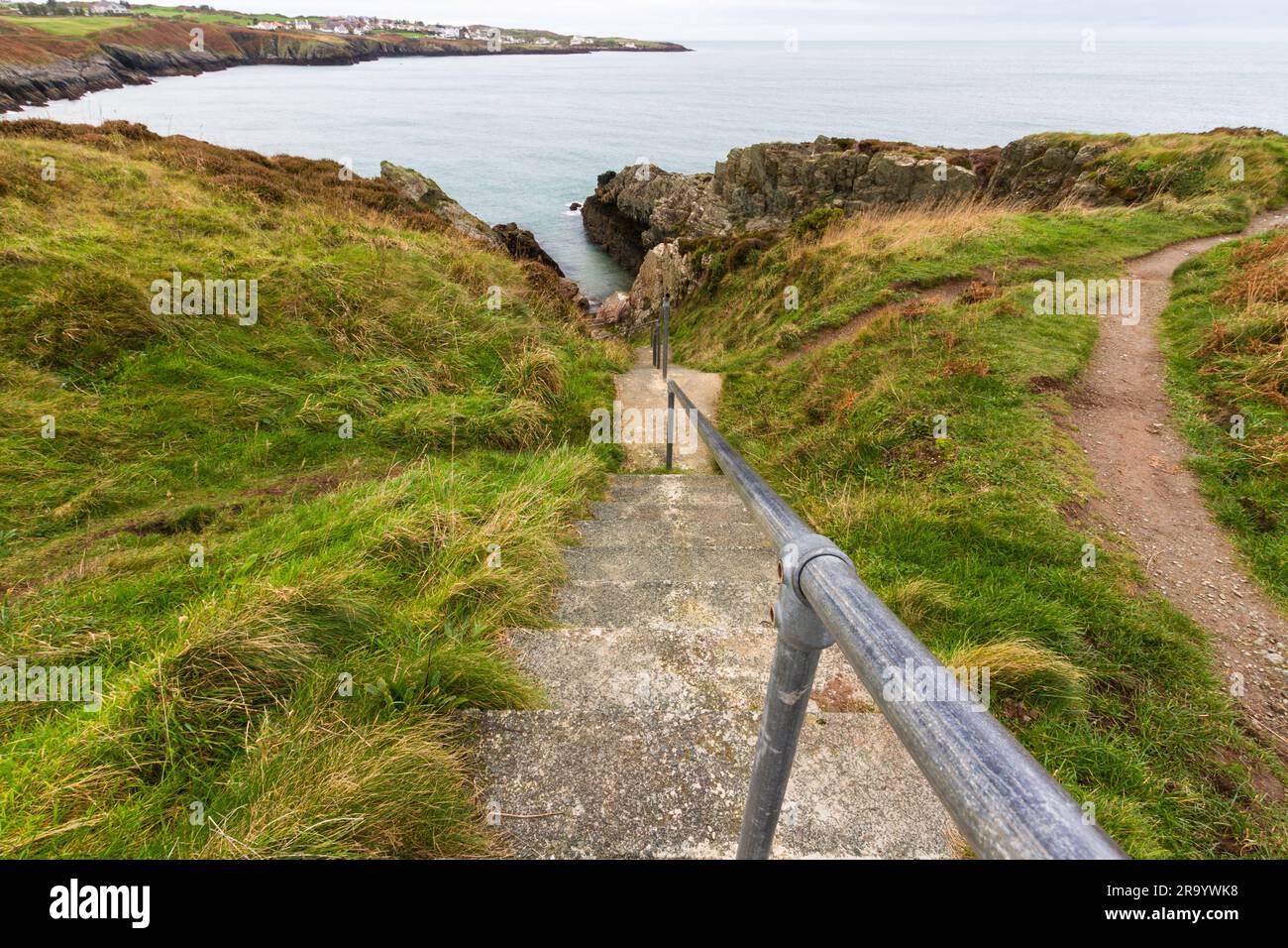 Steps down to the small bay the Creek or Traeth Dynion near Amlwch on the north coast of Anglesey. Stock Photo