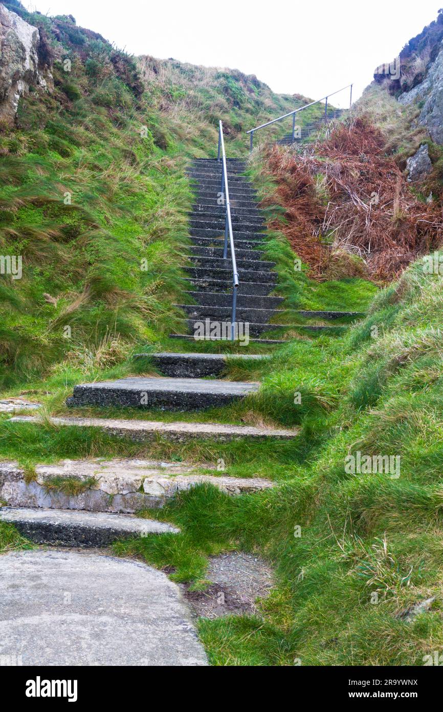 Steps up from the small bay the Creek or or Traeth Dynion near Amlwch on the north coast of Anglesey, portrait Stock Photo