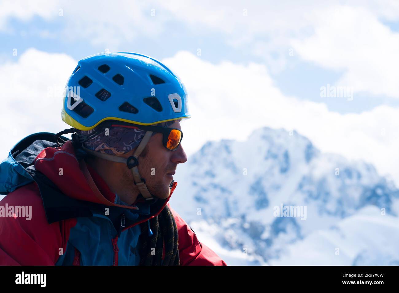A man in special mountaineering glasses with a mirroreffect orange