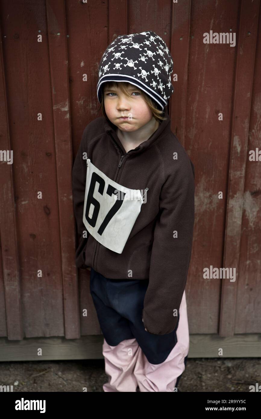 Portrait of an angry little girl with a sports bib Stock Photo - Alamy