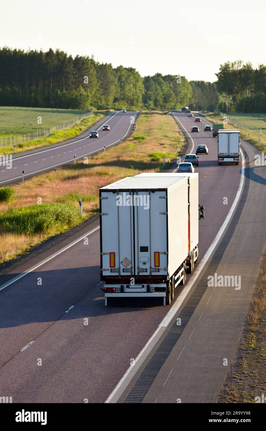 Vehicle Rear Shots Rear shot of vehicles on country highway with trees in the background ...