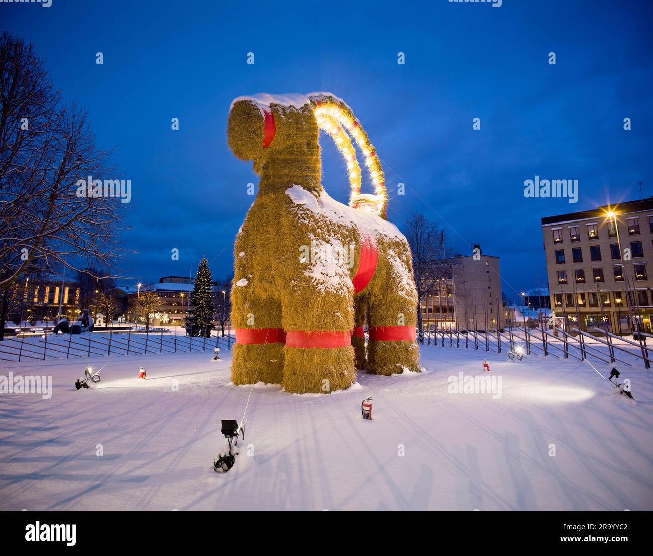 Julbocken (Yule goat) on snow covered landscape against blue sky during Christmas at Gavle, Sweden Stock Photo