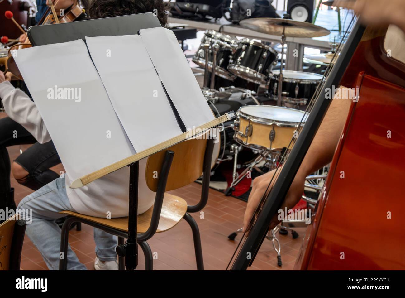 Real life young music students during rehearsals. Musical instruments